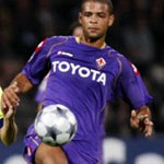 Olympique Lyon's Juninho challenges Melo of Fiorentina during their Champions League soccer match